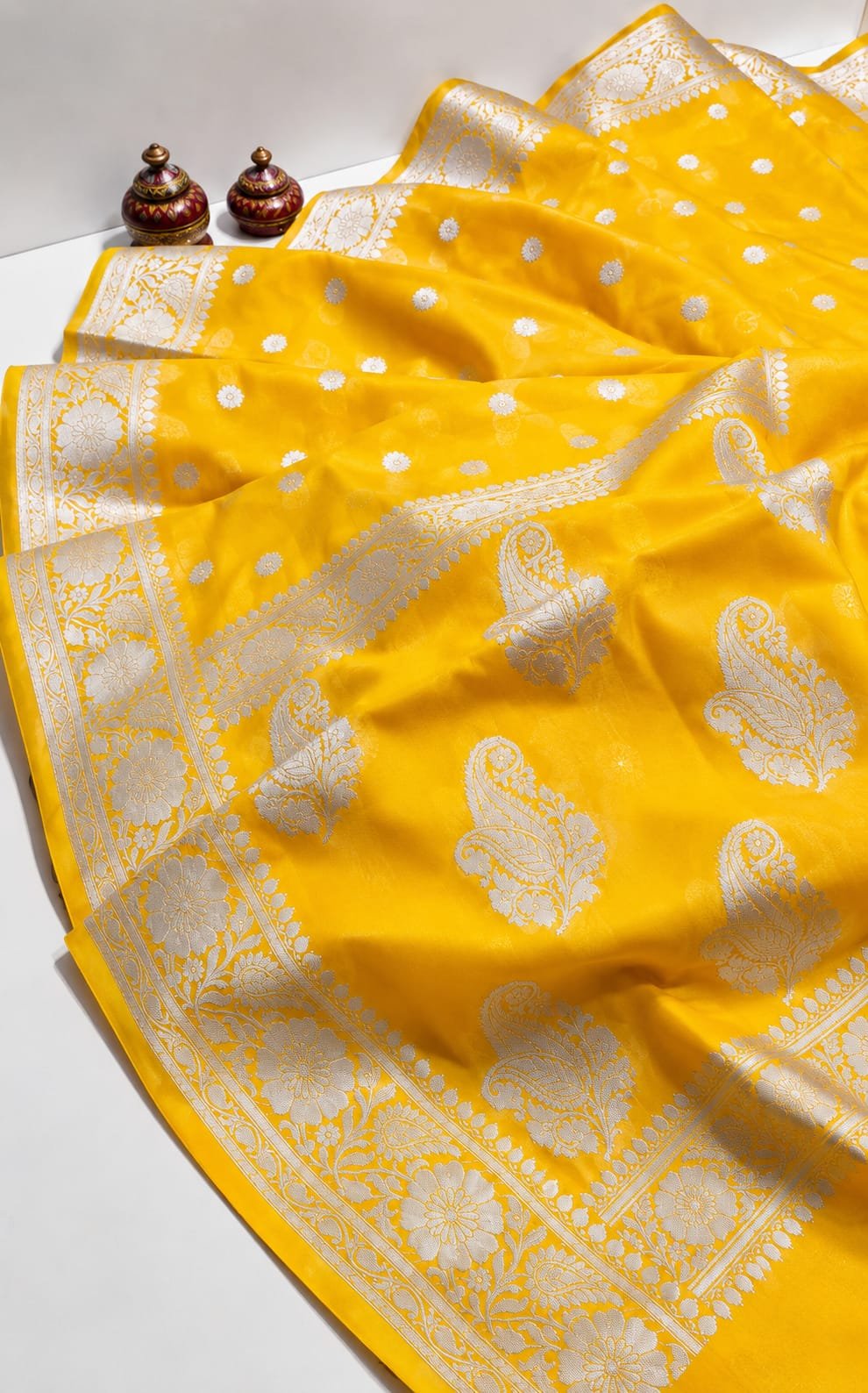 Radiant Mustard Yellow Georgette Banarasi Saree with Silver Zari Paisley Borders